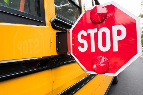 School bus with red stop sign arm extended