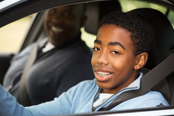 Chicago teen learning how to drive with father in passenger seat