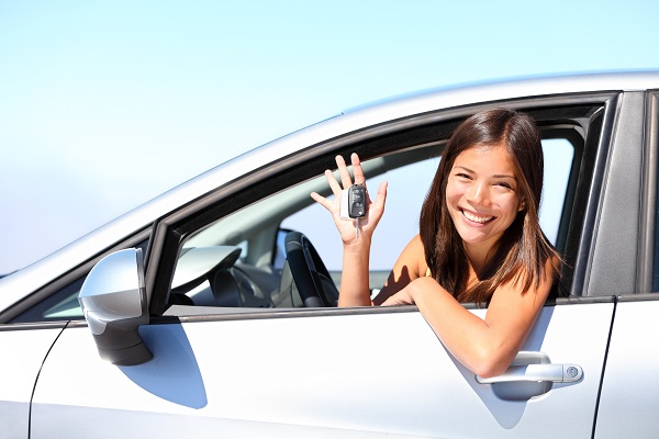 Young teen driver behind the wheel with keys in hand in Illinois