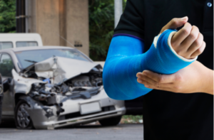 Close up man holding hand with blue bandage as arm injury concept with car accident