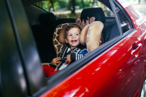 Adorable baby boy in safety car seat.